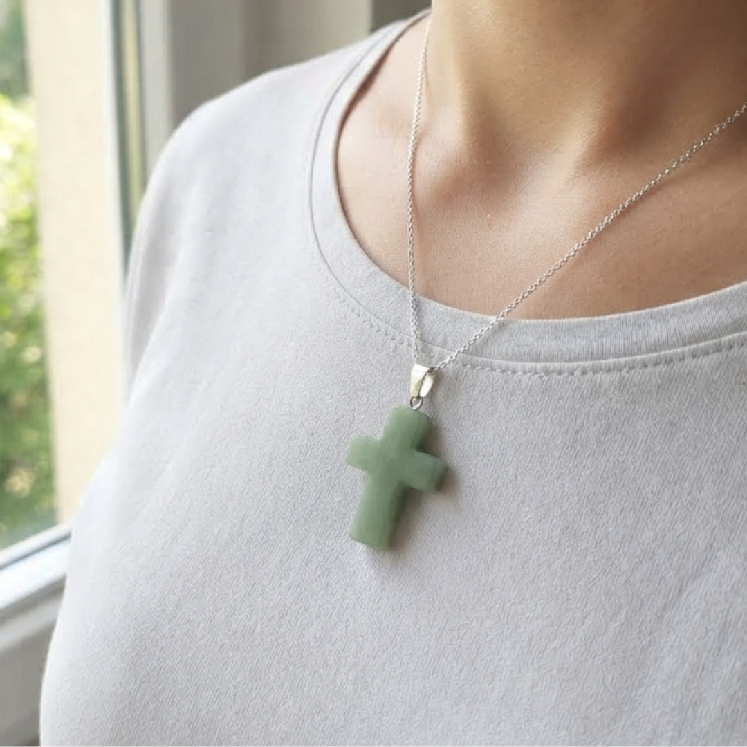 Green Aventurine cross pendant necklace worn on a person with a silver-tone chain