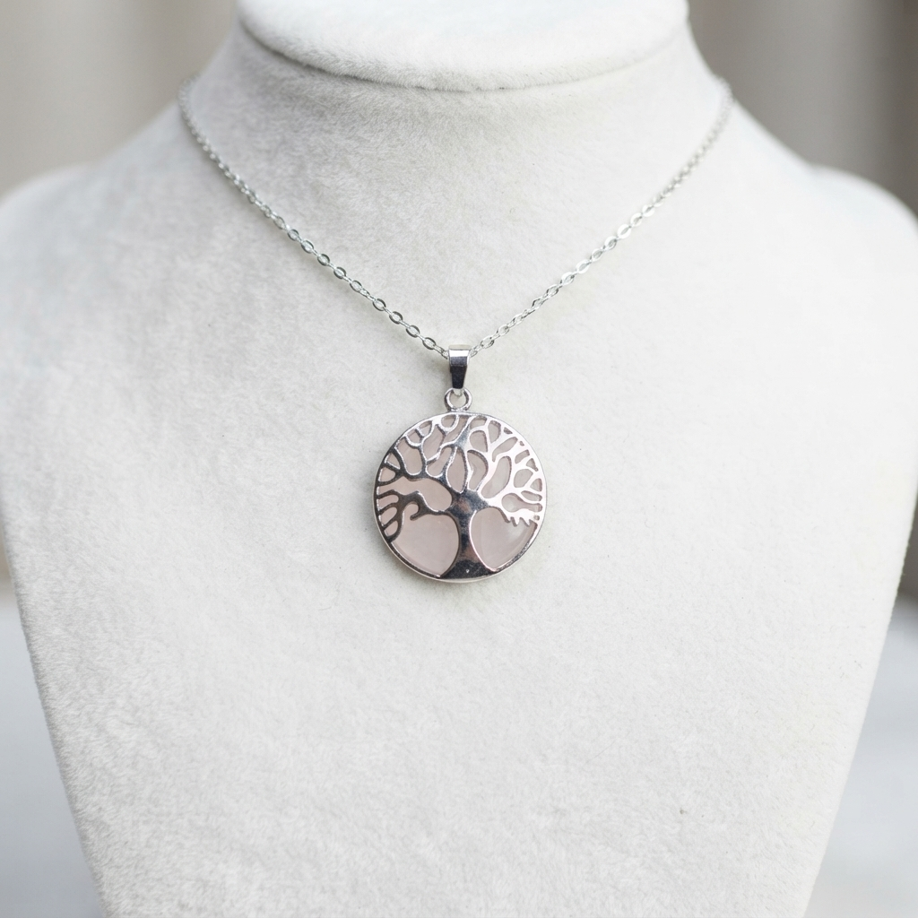 Pink Rose Quartz Tree Of Life jewelry shown on a silver-tone chain