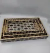 Handcrafted decorative wooden serving tray set with black and gold geometric pattern.