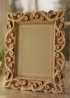 Handcrafted wooden photo frame made from premium mango wood featuring intricate carved scrollwork design for wholesale home décor and gift retailers.