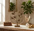 Close-up of brass Tree of Life with birds showing detailed artisan metal craftsmanship