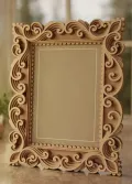 Handcrafted wooden photo frame made from premium mango wood featuring intricate carved scrollwork design for wholesale home décor and gift retailers.