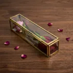 Luxury glass rose box with golden metal frame for elegant home decor and flower display