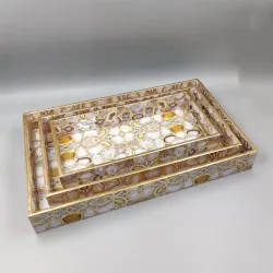 Decorative gold mirrored serving tray set with geometric pattern for luxury home décor.