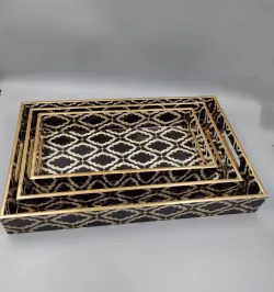 Handcrafted decorative wooden serving tray set with black and gold geometric pattern.